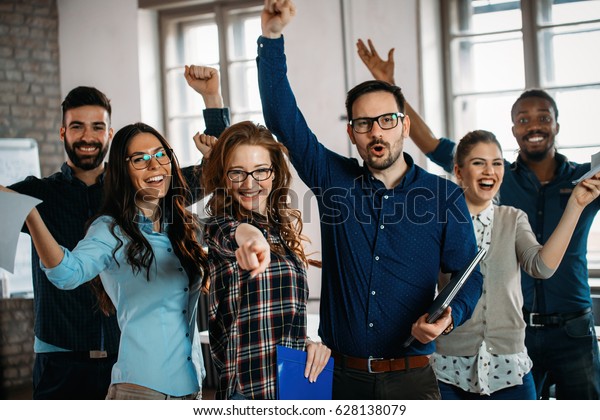 Happy\
group of successful company employees in\
office