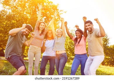 Happy Group As A Successful Team Cheers In The Park At A Team Building Event