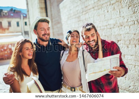 Happy group of tourists traveling and sightseeing together