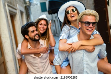 Happy Group Of Young Friends Enjoying Sightseeing Tour In The City On Summer Vacation.