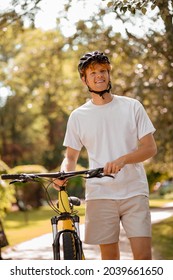 Happy Guy With Bike On Walk In Park