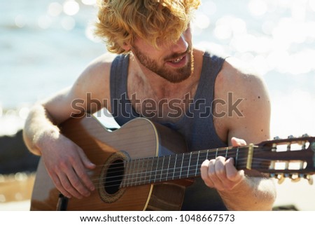 Similar – Young musician enjoying guitar on sunny day