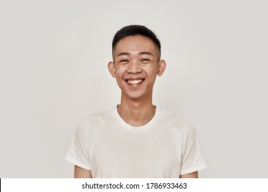 Happy Guy. Portrait Of Young Asian Man With Clean Shaven Face Smiling At Camera Isolated Over White Background. Beauty, Skincare, Health Concept. Front View. Horizontal Shot