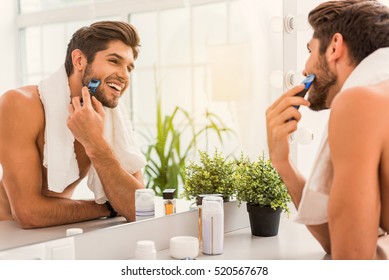 Happy Guy Using Electric Razor