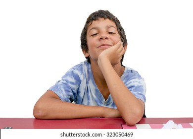 Happy Gypsy Child Boy Sitting At Red School Table, Isolated On White Background