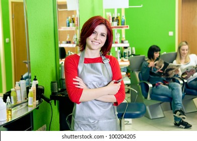 Happy Hair Salon Owner Or Employee With Customers In The Background