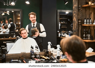 Happy hairdresser showing new haircut to his client. Barber using round mirror to show back view of customer's head. Young male satisfied with new hairstyle. - Powered by Shutterstock