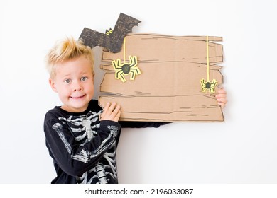 Happy Halloween Background With Blonde Boy And Halloween Decorations Over White Background