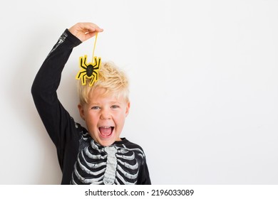 Happy Halloween Background With Blonde Boy And Halloween Decorations Over White Background