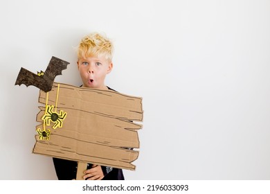 Happy Halloween Background With Blonde Boy And Halloween Decorations 