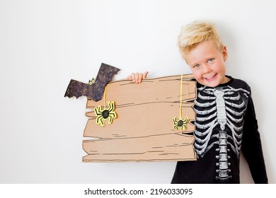 Happy Halloween Background With Blonde Boy And Halloween Decorations Over White Background