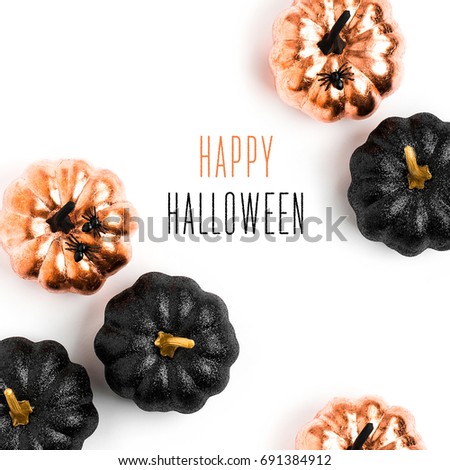 Happy Halloween Card. Stylish  background with black and gold Halloween pumpkin. isolated on white background. Flat lay, top view. 