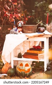 Happy Halloween Carving Pumpkin On The Table In The Garden. Happy Family Preparing For Halloween. Background Photo