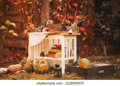 Happy Halloween Carving Pumpkin On The Table In The Garden. Happy Family Preparing For Halloween. Background Photo