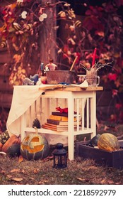 Happy Halloween Carving Pumpkin On The Table In The Garden. Happy Family Preparing For Halloween. Background Photo