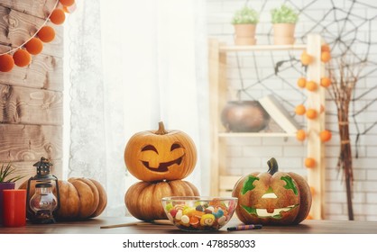 Happy Halloween Carving Pumpkin On The Table In The Home. Happy Family Preparing For Halloween. 