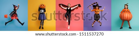 Happy Halloween! Children in carnival costumes on multicolor background. 