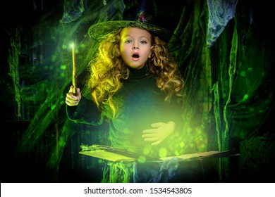 Happy Halloween. Cute Little Witch Casts A Spell On A Secret Book. 