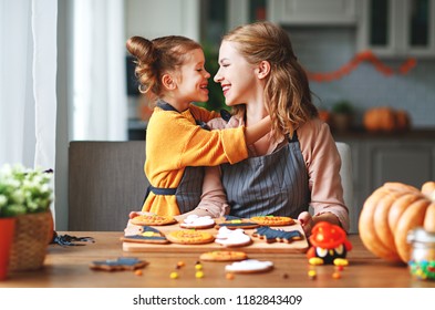 Happy Halloween! Family Mother And Daughter Getting Ready For The Holiday And Baking Cookies
