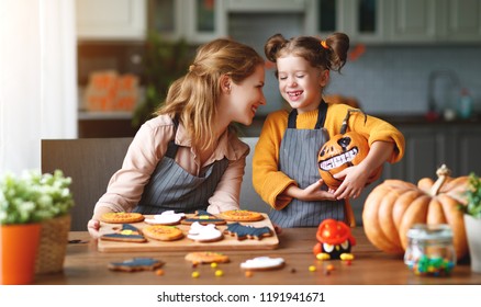 Happy Halloween! Family Mother And Daughter Getting Ready For The Holiday And Baking Cookies
