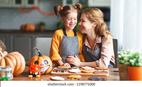 Happy Halloween! Family Mother And Daughter Getting Ready For The Holiday And Baking Cookies
