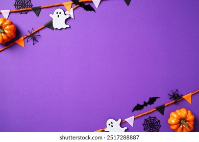 Happy Halloween holiday concept. Frame of Halloween decorations, bats, ghosts, garland, spiders on purple background. Halloween greeting card mockup with copy space. - Powered by Shutterstock