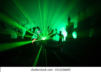 Happy Halloween Horror Party Concept. Scary View Of Dancing Zombies At Cemetery With Dj And Club Lights. Creative Artwork Decoration. Useful As A Party Poster Or Greeting Card. Selective Focus