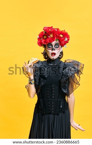 Happy halloween. Katrina. Young surprised woman n in spooky makeup eating delicious hot pizza against bright yellow background. Concept of holidays, party, horror, celebrations, food, sale. ad