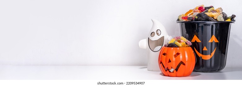 Happy halloween kids holiday background. Various set of halloween holiday buckets with sweets, candies. Trick or treat concept, save space - Powered by Shutterstock