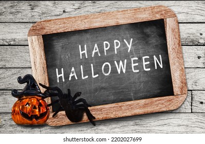 Happy Halloween Made With White Chalk On A Blackboard.  A Pumpkin And Spider In Halloween Day