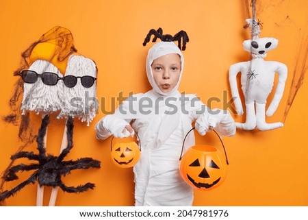 Similar – Foto Bild Happy Halloween.überrascht Kind in einem Skelett-Kostüm mit Popcorn gegen orange Hintergrund