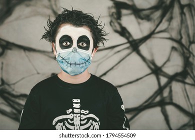 Happy Halloween.Close-up Of Kid Wearing Medical Mask In A Skeleton Costume 
Overgray Background