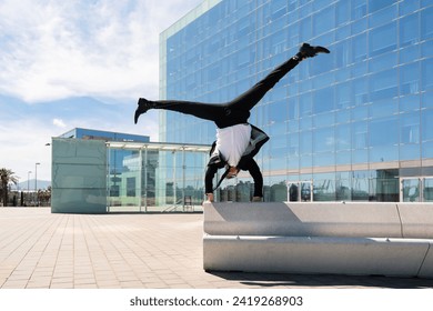 Happy and handsome adult businessman wearing elegant suit doing acrobatic trick moves in the city, alternative concept for business advertisement with energetic and creative people - Powered by Shutterstock