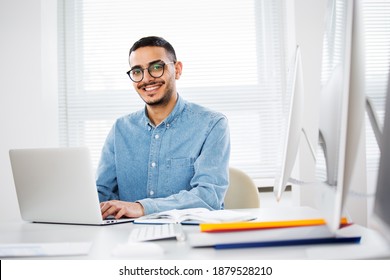 Happy handsome arab businessman smiling while looking at camera in office - Shutterstock ID 1879528210