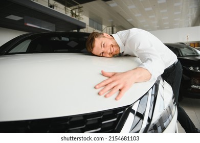 Happy Handsome Bearded Man Buying A Car In Dealership, Guy Hugging Hood Of New Car.