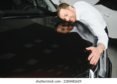 Happy Handsome Bearded Man Buying A Car In Dealership, Guy Hugging Hood Of New Car.