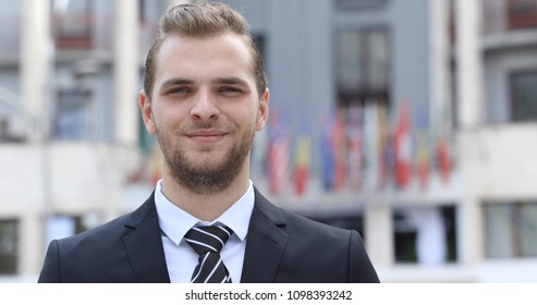 Happy Handsome Business Man Pose Smiling Looking Camera In Front Of International Flags World Economic Forum