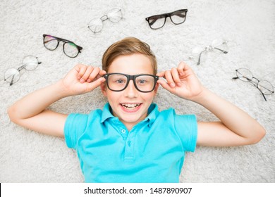 Happy Handsome Child Boy Trying On Glasses. Health, Medicine And Ophthalmology Concept