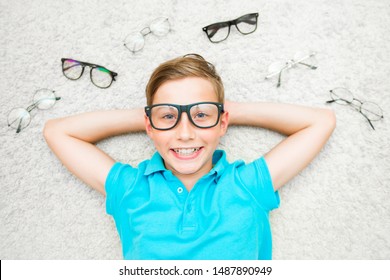 Happy Handsome Child Boy Trying On Glasses. Health, Medicine And Ophthalmology Concept