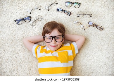 Happy Handsome Child Boy Trying On Glasses. Health, Medicine And Ophthalmology Concept