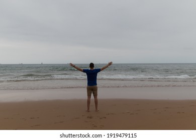 Happy Handsome Man In A Cloudy Beach Day With An Island