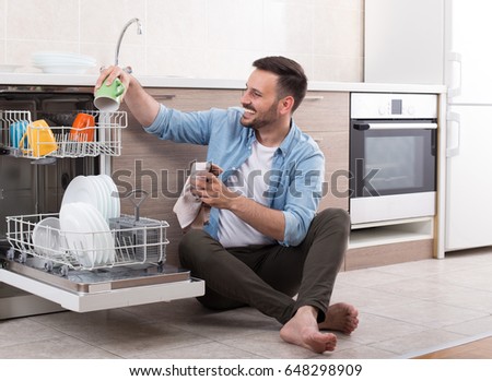 happy-handsome-man-unloading-dishwasher-450w-648298909.jpg