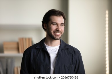 Happy Handsome Millennial Man Looking In Distance, Dreaming Meditating Visualizing Future, Planning Weekend, Imagining Career Opportunities, Posing Indoors, Real Estate Services, Property Concept.