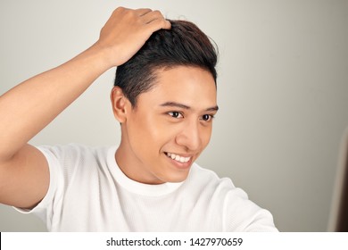 Happy Handsome Smiling Asian Man Touching His Hair