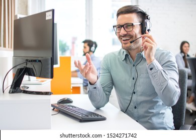 Happy Handsome Technical Support Operator With Headset Working In Call Centre