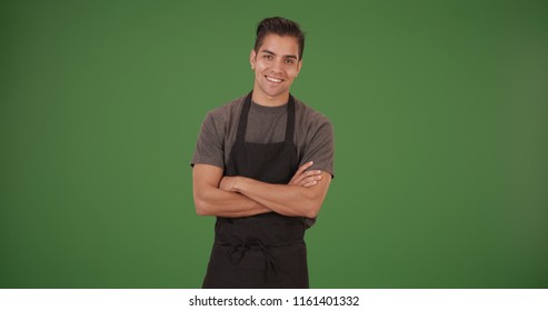 Happy handsome young Latino restaurant employee on green screen