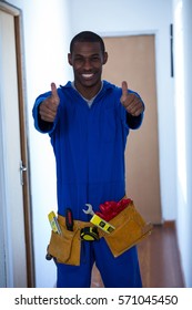 Happy Handy Man Showing His Thumbs Up At Home