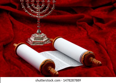 Happy Hanukkah, Religious Spirituality And Praying Concept Theme With Menorah And Torah Scrolls Isolated On Red Velvet Background With Copy Space In Judaic Temple