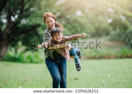 happy harmonious family outdoors concept.mother and son have activities together on holidays.