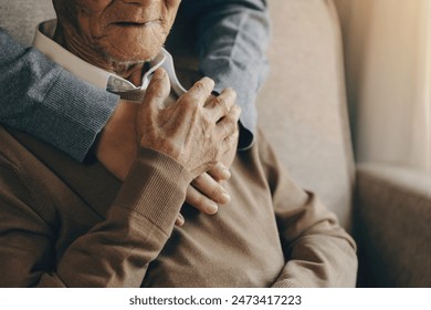 Happy healthcare worker hugging a senior man at home and support encouraging old people. A happy patient is holding the caregiver for a hand while spending time together. Elderly health care concept. - Powered by Shutterstock